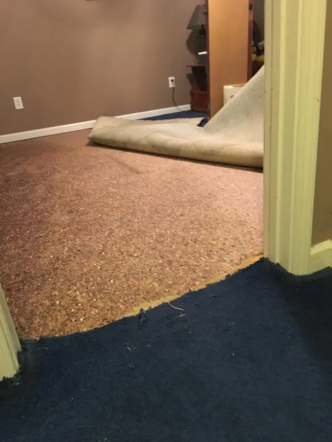 Carpet pad removal revealing water damage during Water Mitigation Services in Boerne